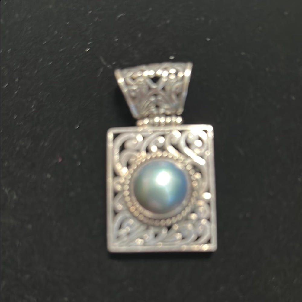 Elegant Silver Pendant with Blue Accent